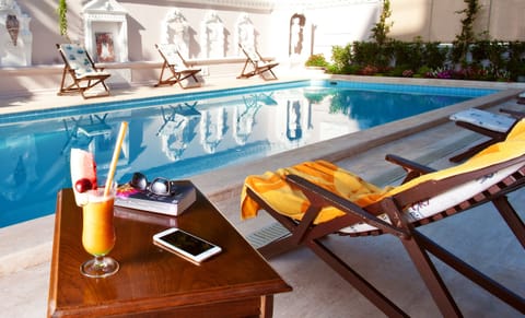 Seasonal outdoor pool, open 10:00 AM to 8:00 PM, pool umbrellas