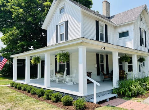 Expansive Covered Front Porch with Rocking Chairs & Seasonal Decorations