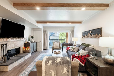 Bright open-concept living room with cozy seating and gas fireplace