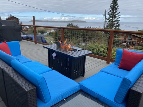 Outdoor patio furniture with fireplace  and view