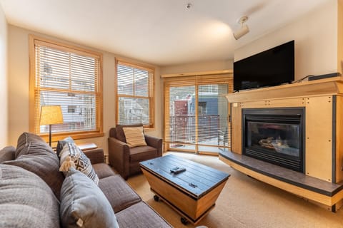 Cozy up in your mountain retreat with plush seating, crackling fireplace, and warm wood accents creating the perfect après-ski sanctuary.