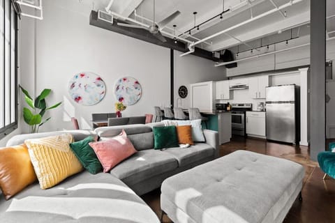 Relax in this cozy living area with stylish decor and soft, inviting pillows.