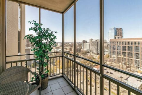 Screened balcony w/ seating & elevated city skyline views