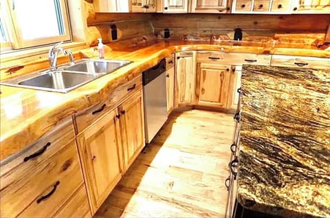 Gorgeous and functional kitchen with split log countertops and granite island. 