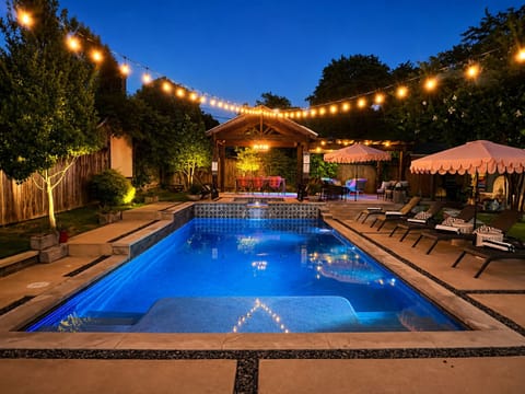 Twilight pool and string lights at The Style Studio, a Fort Worth private pool retreat.
