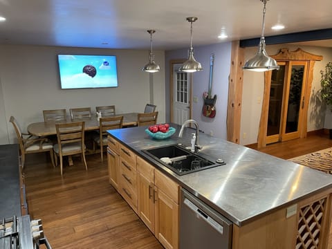 Kitchen with dining room table for eight . Includes big screen TV , bar stools 