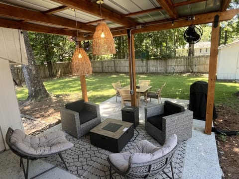 Relax by the fire pit watching tv while your dogs chill in the yard.   Fans help keep the bugs away! 