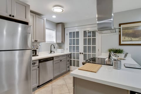 Newly renovated kitchen.  French doors lead to full laundry.