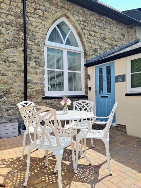 Courtyard patio with table and chairs.