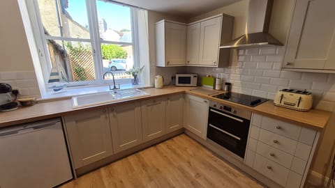 Kitchen with plenty of utensils, crockery and cutlery.