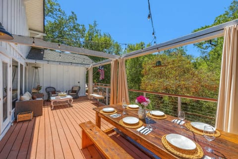 Light pours through skylights into this airy dining room, opening to a serene garden path. A cheerful, inviting space where meals and memories come naturally.