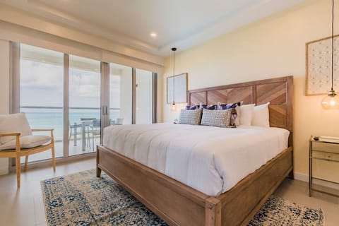 Drift to sleep in your coastal bedroom with crisp linens and stunning sea views framed by floor-to-ceiling windows. Wake to the ocean's gentle rhythm beyond your private balcony.
