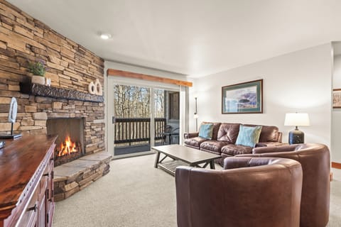 Snow Flower 149 offers a cozy gas burning fireplace while enjoying forest views from the living room in this inviting condominium.