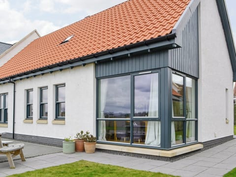 Rear of property with paved path and patio | Strathspey - Paddockhall Cottages, Linlithgow, near Edinburgh 