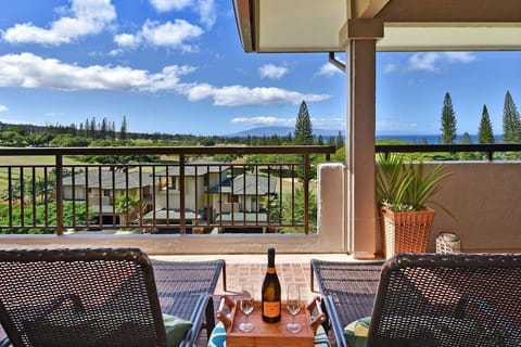 Golf course and ocean view lanai with outdoor dining and lush tropical scenery