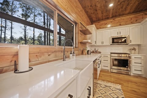 Convenient kitchen pass-through window makes it easy to serve meals and drinks to guests enjoying the outdoor deck.