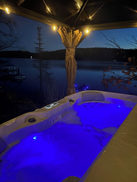 Experience the ultimate relaxation in hot tub with breathtaking views of lake