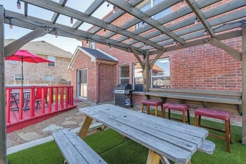 Step into your private outdoor oasis, where relaxation and entertainment go hand in hand. This backyard retreat boasts a covered picnic area, built-in bar seating, and a spacious deck complete with a grill.