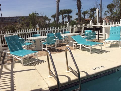 Lounge area at pool charcoal grills