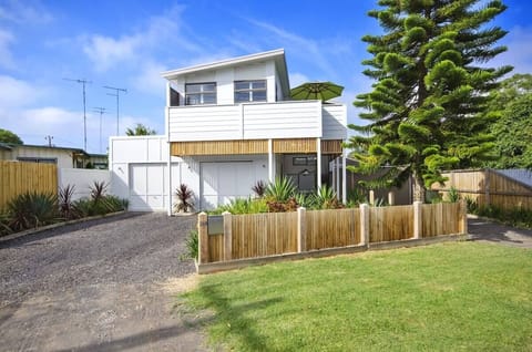 The home is characterised by soaring raked ceilings, polished bamboo floors and louvre shutters.
