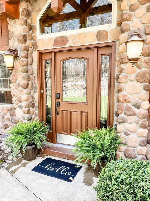 Big timber, cozy stonework, and a front porch made for morning coffee and quiet moments.