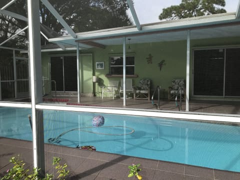 Screened Pool with dining table and full sized refrigerator