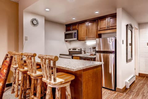 Breakfast bar seating for 4 with a full kitchen.