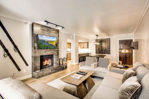 Beautifully updated condo, modern mountain design, spacious living room with large sectional and feature fireplace wall