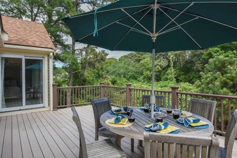 The backyard deck with outdoor dining table set for six.