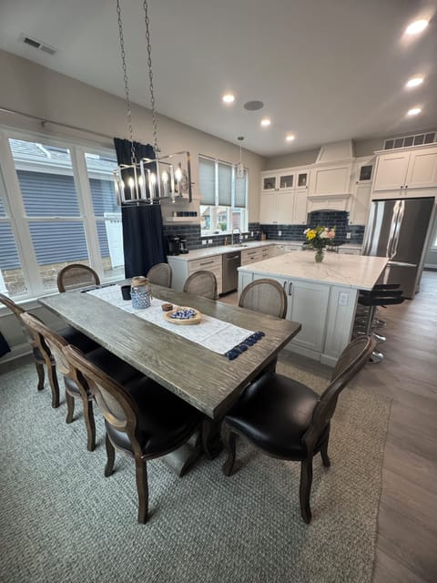 Dining area. Table seats 8, barstools at island for additional seating. 