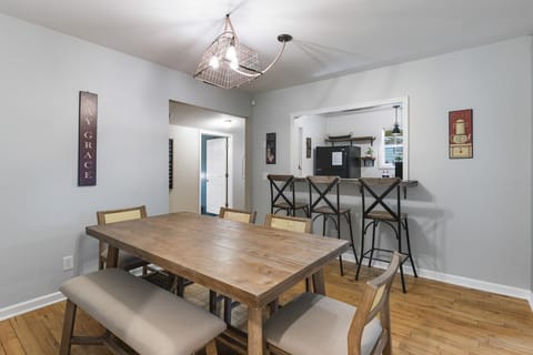 Dining room table with plenty of seating plus additional bar seating at the kitchen counter.