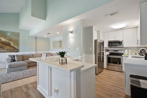 Kitchen with new stainless steel appliances & fully stocked with pots, pans, dish-ware and utensils.