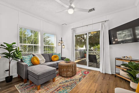 The beautiful sun-filled living area with a large wall mounted Smart TV with Netflix