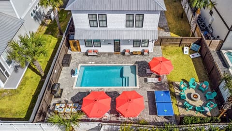 A private backyard oasis with pool, fire pit, outdoor dining, games, and plenty of space to relax.