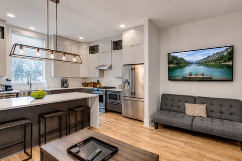 Open-concept living room and kitchen with a spacious layout, perfect for gathering, entertaining, and relaxing together.