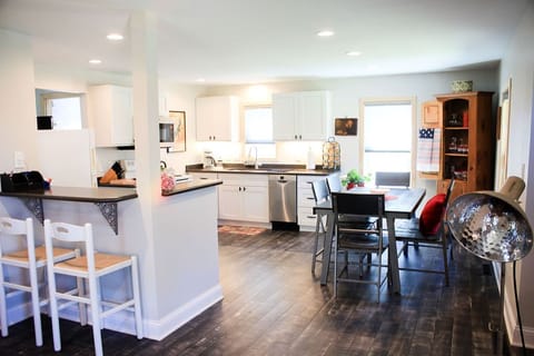 Open style floor plan with a well equipped kitchen and large dining table.
