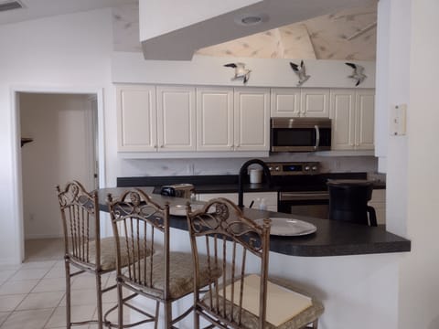A view of the breakfast bar looking into the kitchen.