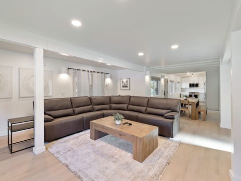 A spacious living room, complete with a comfortable sofa for relaxing.