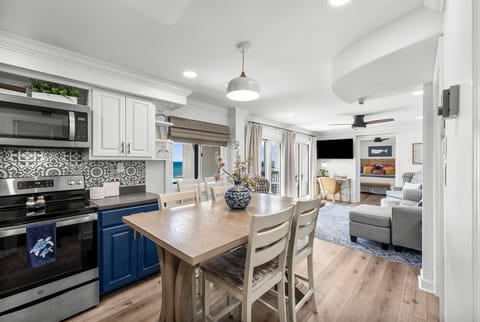 Fully equipped kitchen with counter height table and ocean view.