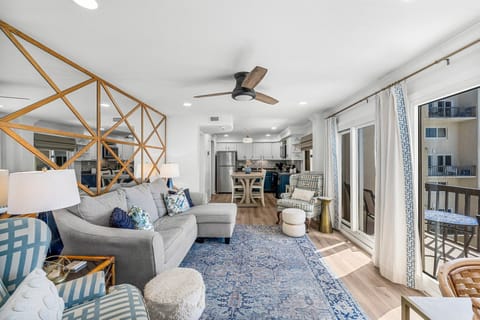 Professionally decorated living room with sectional sofa and ocean views