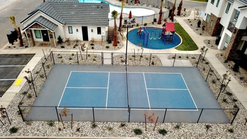 This Washington, Utah home offers fun for all ages with a pickleball court and playground, just minutes from St. George attractions.