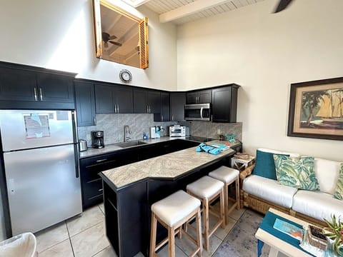 Your kitchen includes a peninsula bar with stools. A perfect spot to plan your daily excursions.