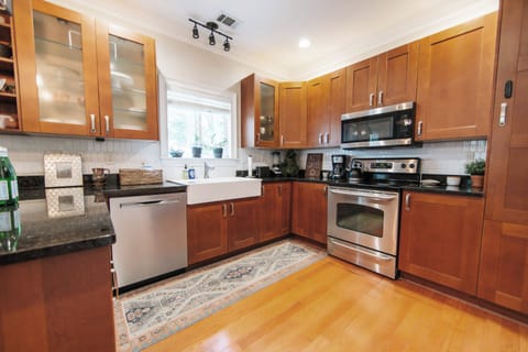 Prepare local finds among stainless appliances and warm wood cabinetry.