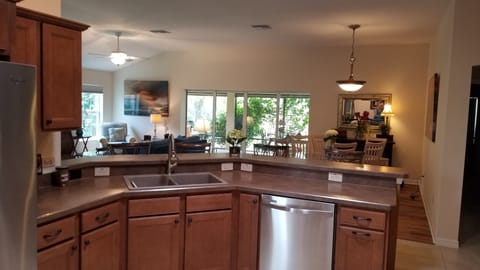 KITCHEN LOOKING INTO LIVING AREA AND DINING ROOM