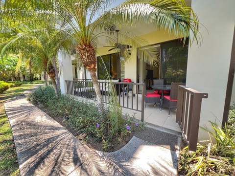 Relax and enjoy the tropical surroundings on your private terrace with walkout to the pool pathway.  