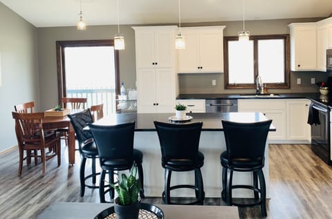Modern kitchen includes granite countertops and new appliances.