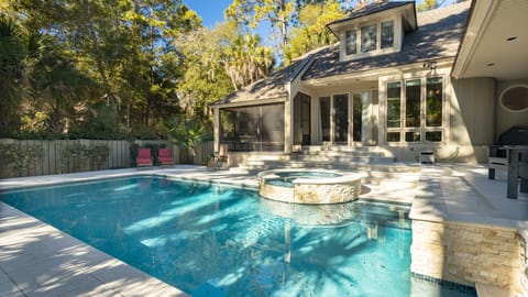 Featuring a sparkling pool, inviting lounge chairs, and a tranquil spa.