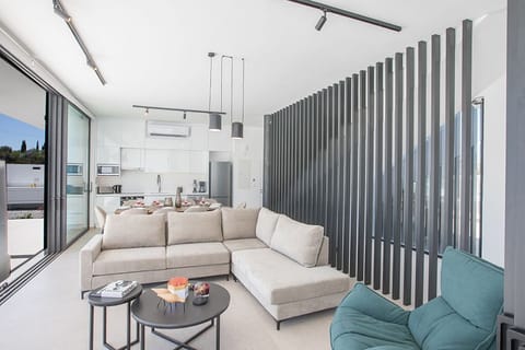 Living room with comfortavle corner sofa, coffee table and Smart TV