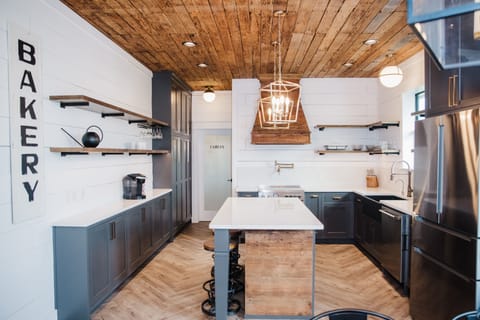 Open kitchen with farmhouse sink and Delta Touch faucet.