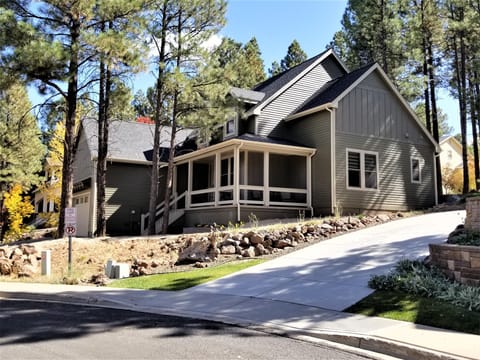 Custom Boulder Point luxury exterior beautifully framed by vibrant fall foilage.